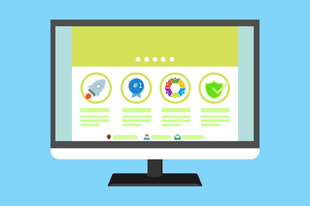 A computer monitor displays a website with four highlighted features, each represented by different icons: a rocket, a blue badge, a colorful star, and a green shield, set against a light blue background.